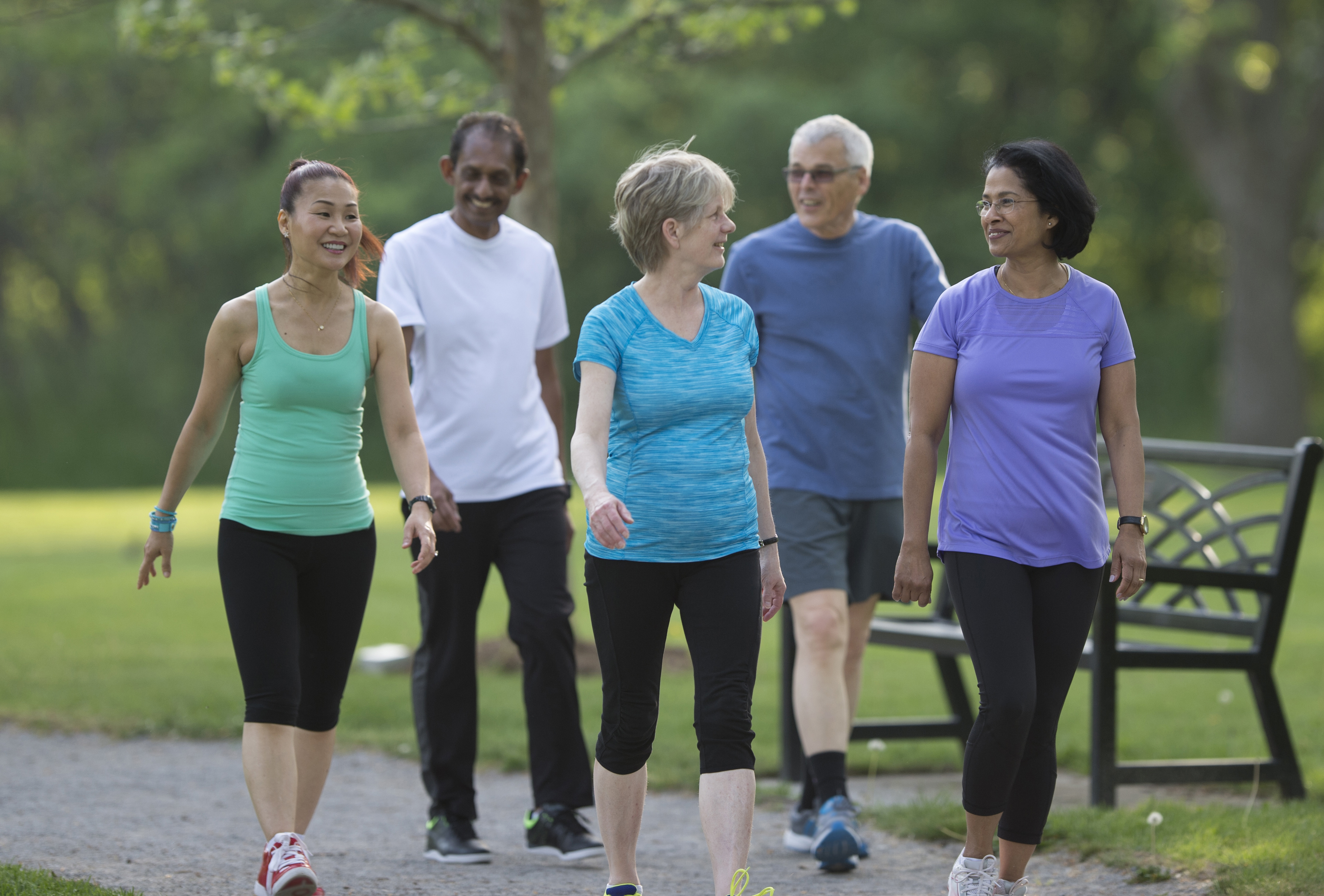 A group  of five people enjoying a walk. 